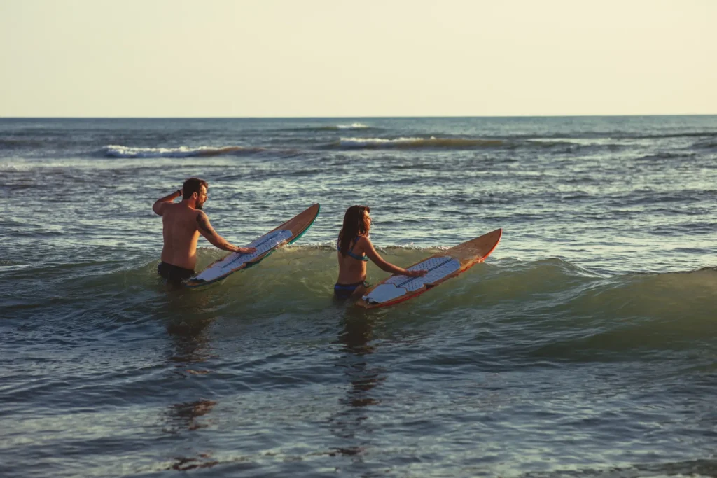 couple enjoying surf boards in gentle ocean waves 2026 03 24 09 59 27 utc