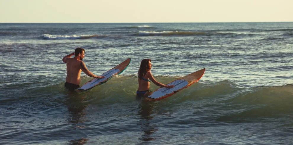 couple enjoying surf boards in gentle ocean waves 2026 03 24 09 59 27 utc